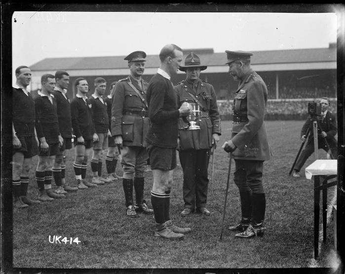 King George V presents a cup to the captain of the winning New Zealand Services Rugby Team, London.